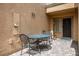 Cozy outdoor patio with a wrought-iron table and chairs, perfect for relaxing and entertaining at 9000 Sundial Dr, Las Vegas, NV 89134
