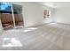 Bright bedroom featuring neutral carpeting, a sliding glass door to the backyard, and a window for natural light at 9267 Lapeer St, Las Vegas, NV 89178