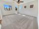 Bright bedroom with neutral carpeting, ceiling fan, and a well-lit atmosphere, perfect for relaxation at 9267 Lapeer St, Las Vegas, NV 89178