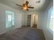 Bedroom featuring neutral carpeting, ceiling fan and entrances to a bathroom, closet and other rooms at 9267 Lapeer St, Las Vegas, NV 89178