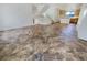 Open-concept living room with tile flooring, staircase, and adjacent kitchen area, perfect for modern living and entertaining at 9267 Lapeer St, Las Vegas, NV 89178