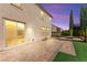 Evening shot of backyard with brick patio, firepit and sliding glass door access at 9277 Ardoa Ave, Las Vegas, NV 89148