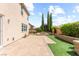 Wide backyard featuring a brick patio, manicured grass and a vibrant garden at 9277 Ardoa Ave, Las Vegas, NV 89148