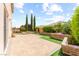 Beautifully landscaped backyard with a spacious patio and lush greenery at 9277 Ardoa Ave, Las Vegas, NV 89148