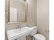 Cozy powder room with pedestal sink, framed mirror, and neutral paint at 9277 Ardoa Ave, Las Vegas, NV 89148