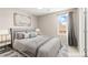 Comfortable bedroom with serene decor and a large window overlooking the neighborhood at 9277 Ardoa Ave, Las Vegas, NV 89148