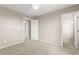 Neutral-toned bedroom with carpet flooring and a walk-in closet for storage at 9277 Ardoa Ave, Las Vegas, NV 89148