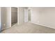 Neutral carpeted bedroom with a closed closet door and a view of the neighborhood outside at 9277 Ardoa Ave, Las Vegas, NV 89148