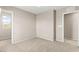 Carpeted bedroom featuring a large window, closet, with neutral color paint and ample natural light at 9277 Ardoa Ave, Las Vegas, NV 89148