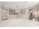 Bright dining room with modern chandelier and view into entry with stairs at 9277 Ardoa Ave, Las Vegas, NV 89148