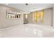 Bright dining area with modern chandelier and yellow accent curtains at 9277 Ardoa Ave, Las Vegas, NV 89148