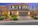 Charming two-story home featuring a well-manicured front yard and a two-car garage at 9277 Ardoa Ave, Las Vegas, NV 89148