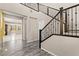 Grand foyer with hardwood floors, soaring ceilings, and elegant staircase at 9277 Ardoa Ave, Las Vegas, NV 89148