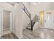 Welcoming entryway with modern chandelier and staircase, adjacent to living space at 9277 Ardoa Ave, Las Vegas, NV 89148