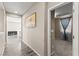 Hallway with modern flooring leading to a bedroom and other living spaces at 9277 Ardoa Ave, Las Vegas, NV 89148