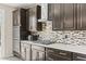 Well-equipped kitchen featuring sleek cabinets, stainless steel appliances, and a decorative backsplash at 9277 Ardoa Ave, Las Vegas, NV 89148