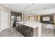 Modern kitchen with a large island, stainless steel appliances, and pendant lighting at 9277 Ardoa Ave, Las Vegas, NV 89148
