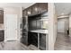Modern kitchen featuring wine storage, stainless steel fridge, and wood-look floors at 9277 Ardoa Ave, Las Vegas, NV 89148