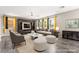 Staged living room with a plush sofa, modern furniture, and a stylish entertainment center at 9277 Ardoa Ave, Las Vegas, NV 89148