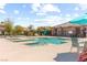 Community pool with lounge seating, swimming pool, and a clubhouse building at 9277 Ardoa Ave, Las Vegas, NV 89148