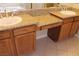 Bathroom features double sinks with granite countertops and wooden cabinets at 932 Tafalla Ct, Las Vegas, NV 89138
