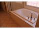 A luxurious soaking tub with a chrome faucet and window for natural light at 932 Tafalla Ct, Las Vegas, NV 89138