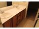 Bathroom vanity featuring double sinks, oak cabinets, and tile flooring at 932 Tafalla Ct, Las Vegas, NV 89138