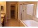 Bright bathroom features a walk-in shower, soaking tub, and spacious walk-in closet at 932 Tafalla Ct, Las Vegas, NV 89138
