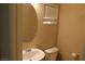 Cozy bathroom features a toilet, sink, and a vanity mirror at 932 Tafalla Ct, Las Vegas, NV 89138