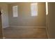 Empty bedroom features neutral paint, carpet, and two windows with blinds for natural light at 932 Tafalla Ct, Las Vegas, NV 89138