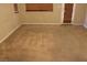 Bedroom featuring neutral carpeting, a window with wood blinds and an entrance to patio at 932 Tafalla Ct, Las Vegas, NV 89138