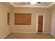 Bedroom featuring neutral carpeting, a window with wood blinds and an entrance to patio at 932 Tafalla Ct, Las Vegas, NV 89138