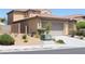 Tan two-story home showcasing a tile roof and a two-car garage at 932 Tafalla Ct, Las Vegas, NV 89138