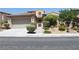 Tan two-story home with well-manicured landscaping at 932 Tafalla Ct, Las Vegas, NV 89138