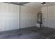 Unfinished garage space with gray painted floor and utility installations at 932 Tafalla Ct, Las Vegas, NV 89138