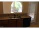 The kitchen features a double sink, wooden cabinets, and light countertops at 932 Tafalla Ct, Las Vegas, NV 89138