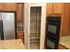 Kitchen featuring a pantry, stainless steel refrigerator, and double ovens at 932 Tafalla Ct, Las Vegas, NV 89138