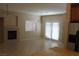 Open living area featuring a fireplace, tile floors, and access to the backyard at 932 Tafalla Ct, Las Vegas, NV 89138