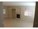 Open living room with a fireplace, tile floors, and chandelier lighting at 932 Tafalla Ct, Las Vegas, NV 89138