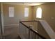 A loft space with neutral carpeting, natural light, and a railing overlooking the lower level at 932 Tafalla Ct, Las Vegas, NV 89138