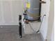 Water heater installed on a platform with electrical and plumbing connections at 932 Tafalla Ct, Las Vegas, NV 89138