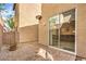Private backyard with desert landscaping, a sliding glass door, and an exterior wall at 9343 Clear Day Ln, Las Vegas, NV 89178