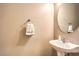 Powder room with pedestal sink, round mirror and a towel ring at 9343 Clear Day Ln, Las Vegas, NV 89178