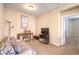 Bedroom featuring a sofa, desk, TV, a side lamp, and an open doorway at 9343 Clear Day Ln, Las Vegas, NV 89178
