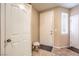Bright foyer featuring tile flooring, white doors, a small stool and natural light from window at 9343 Clear Day Ln, Las Vegas, NV 89178