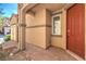 Inviting entryway with a brick walkway leading to a red front door, offering a warm welcome at 9343 Clear Day Ln, Las Vegas, NV 89178