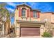 Charming two-story home with attached two-car garage, red shutters, and desert landscaping at 9343 Clear Day Ln, Las Vegas, NV 89178