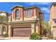Charming two-story home with attached two-car garage, red shutters, and manicured desert landscaping at 9343 Clear Day Ln, Las Vegas, NV 89178