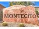 Entrance sign 'Montecito' set on a large rock, surrounded by desert vegetation at 9343 Clear Day Ln, Las Vegas, NV 89178