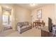 Cozy sitting area with love seat and desk space bathed in natural light, perfect for relaxation and home office at 9343 Clear Day Ln, Las Vegas, NV 89178